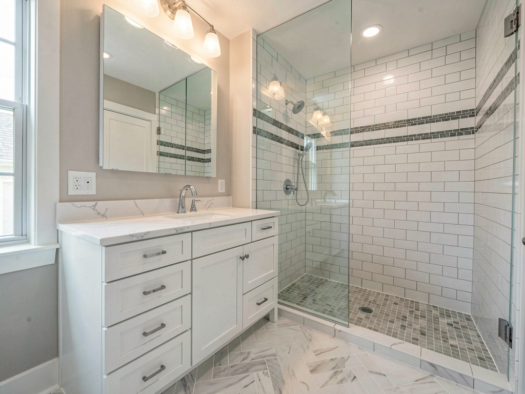 Mid-range bathroom remodel cost with herringbone tile floor and quartz vanity
