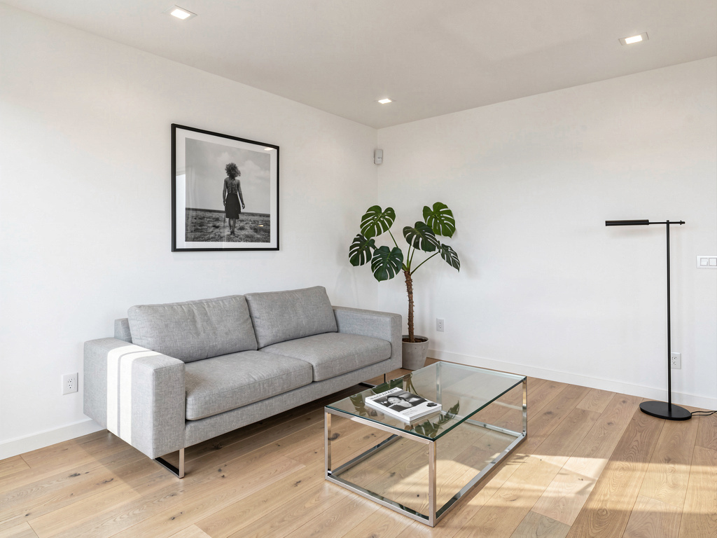 Modern living room with contemporary clean design, light gray sofa and glass coffee table