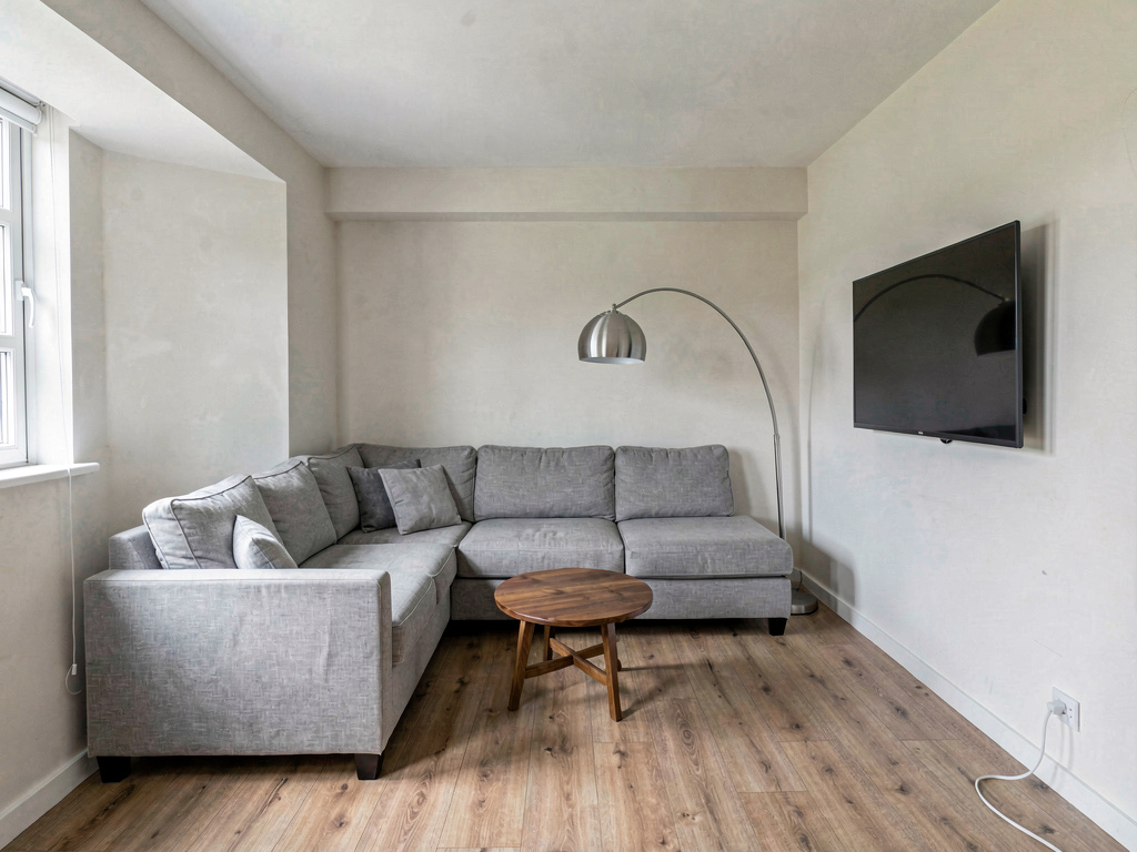 Small living room layout with L-shaped sectional tucked into the corner